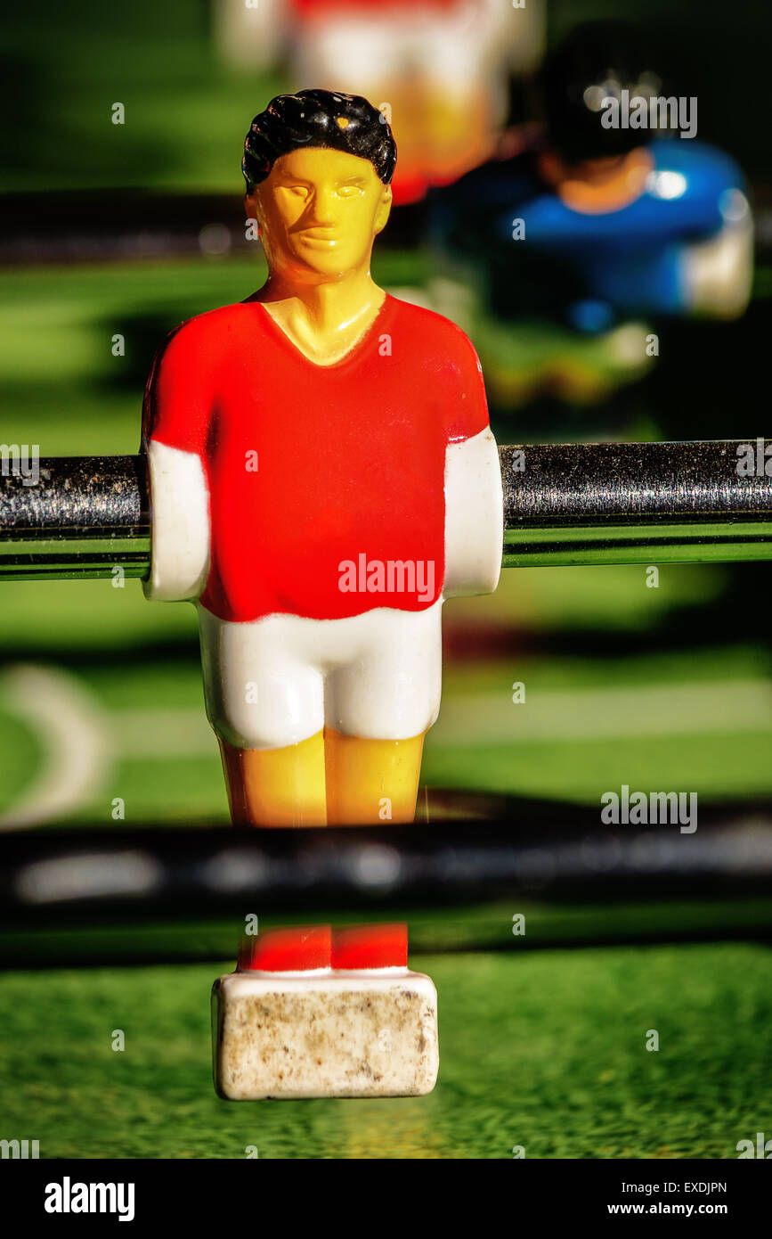 Vintage Table Soccer Player Figure, Single Player in Red Jersey, Selective Focus, Retro Tone Effect Stock Photo