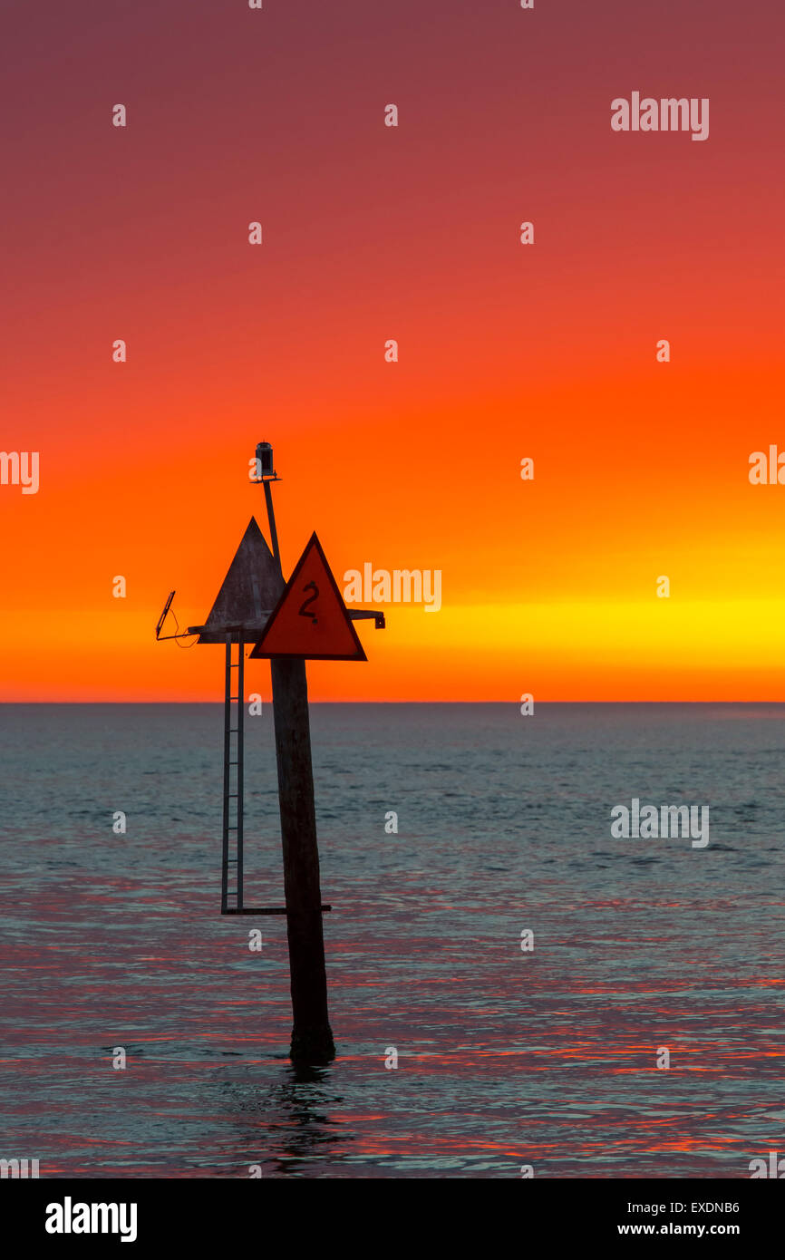 Navigational waterway markers in the Gulf of Mexico at the Jetty in Venice Florida with sunset sky Stock Photo