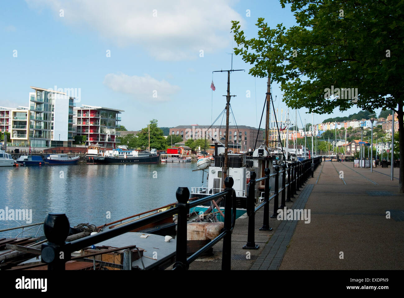 Documentary images of Bristol Harbourside showing boats docked in the water with waterside development in the background. Stock Photo