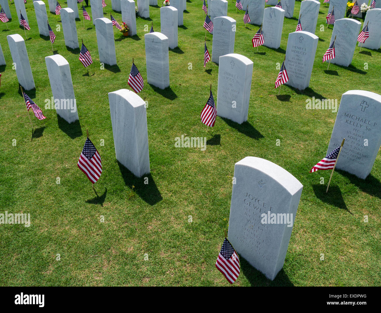 American flags on grave head stones in Sarasota National Cemetery in Sarasota Florida Stock Photo