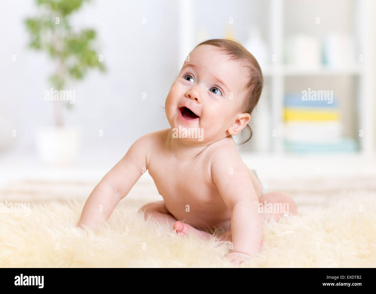 baby sitting on floor at home Stock Photo