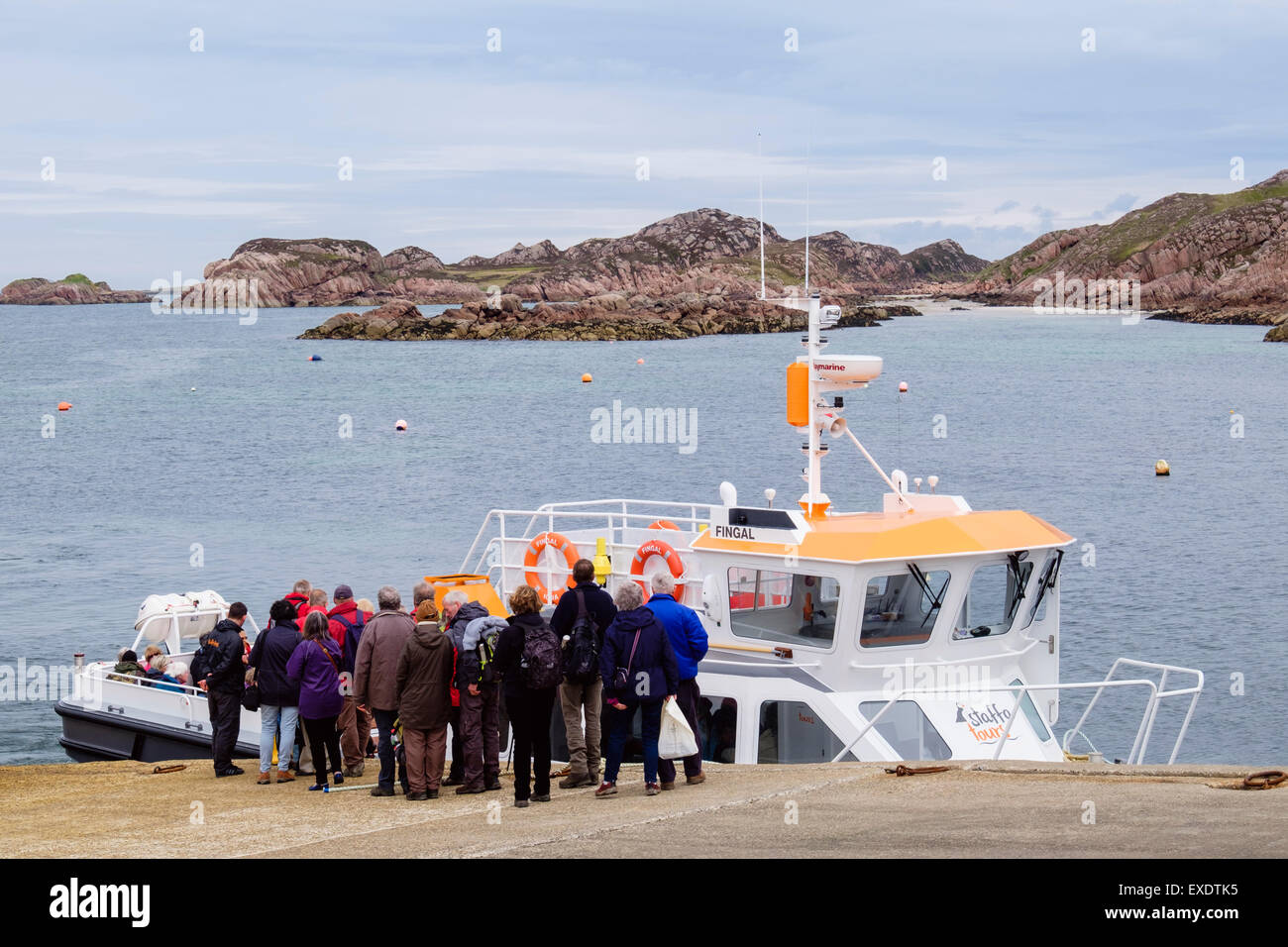 Tourists waiting to board boat for Staffa Island and Fingal's cave tour. Fionnphort, Isle of Mull, Inner Hebrides, Scotland, UK Stock Photo