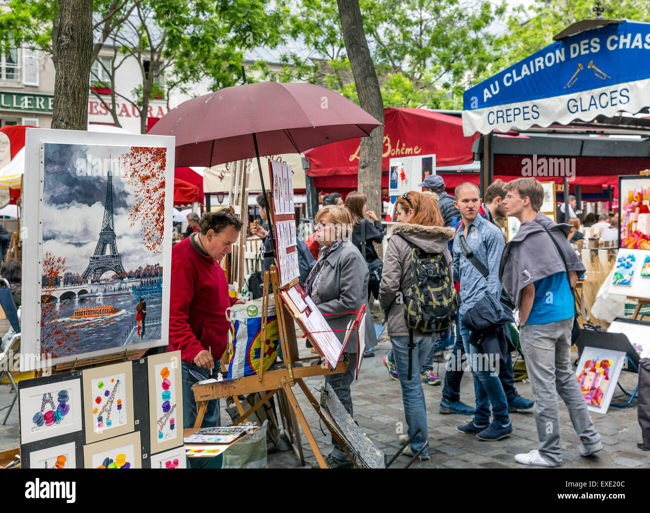 Tourists visiting Place du Tertre in Montmartre, one of the most touristic attractions of Paris Stock Photo