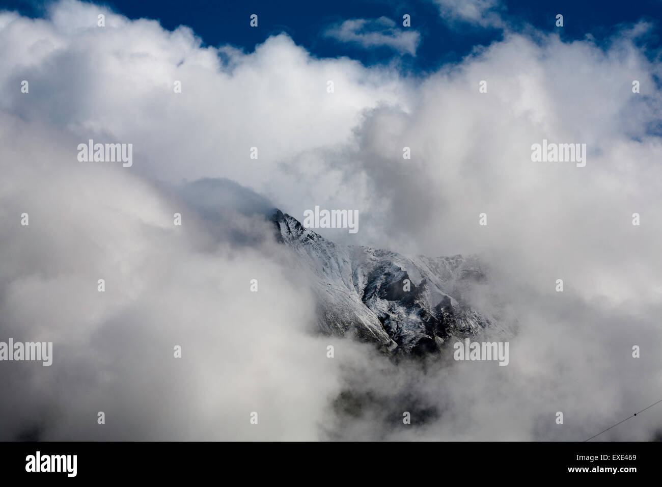 Cloud and mist swirling around mount summits above Kaprun Hohe Tauern National Park  Pinzgau Salzburgerland Austria Stock Photo