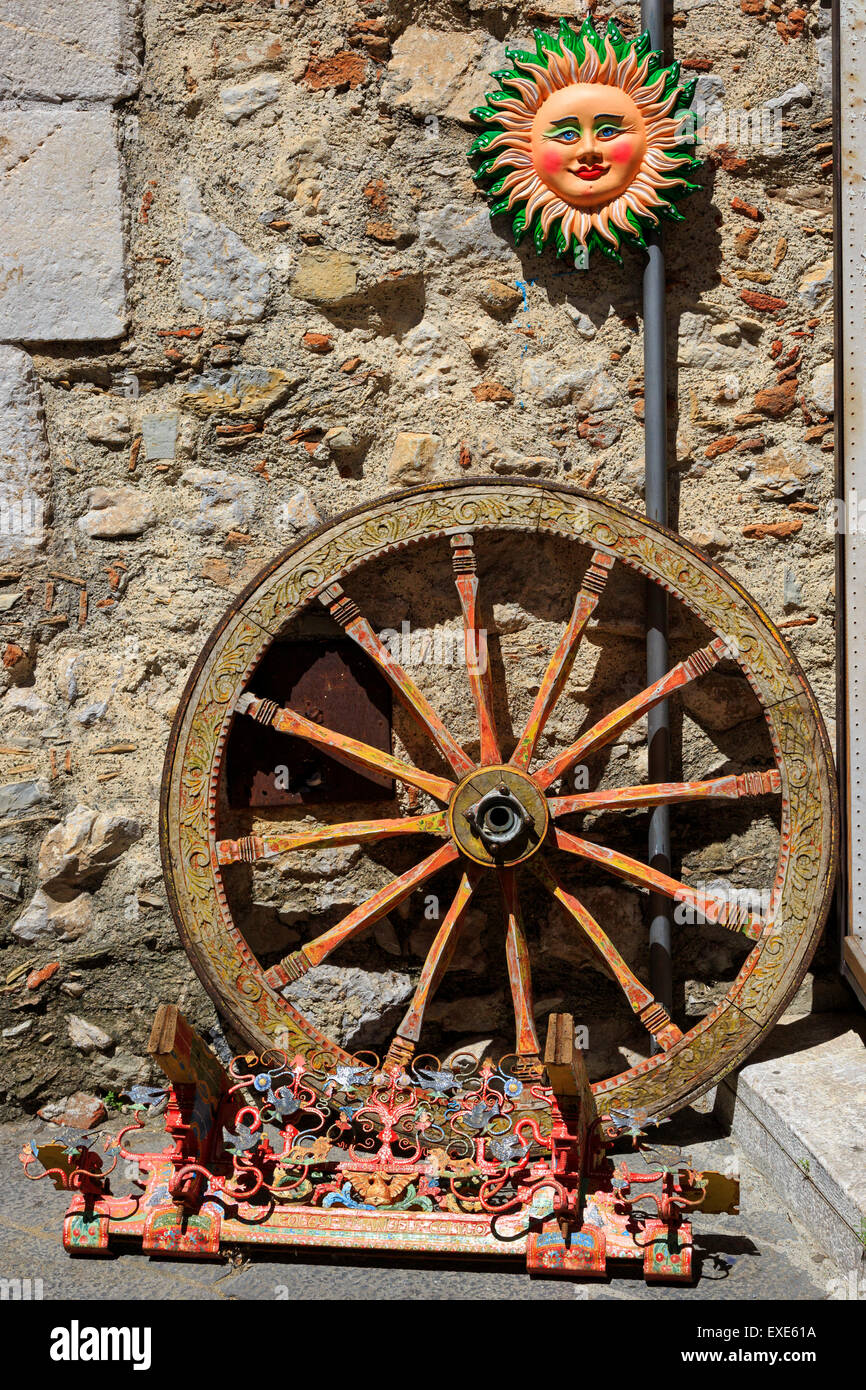 Traditional Sicilian cart wheel and  ornate metallic couplings from a hand cart, Sicily Stock Photo