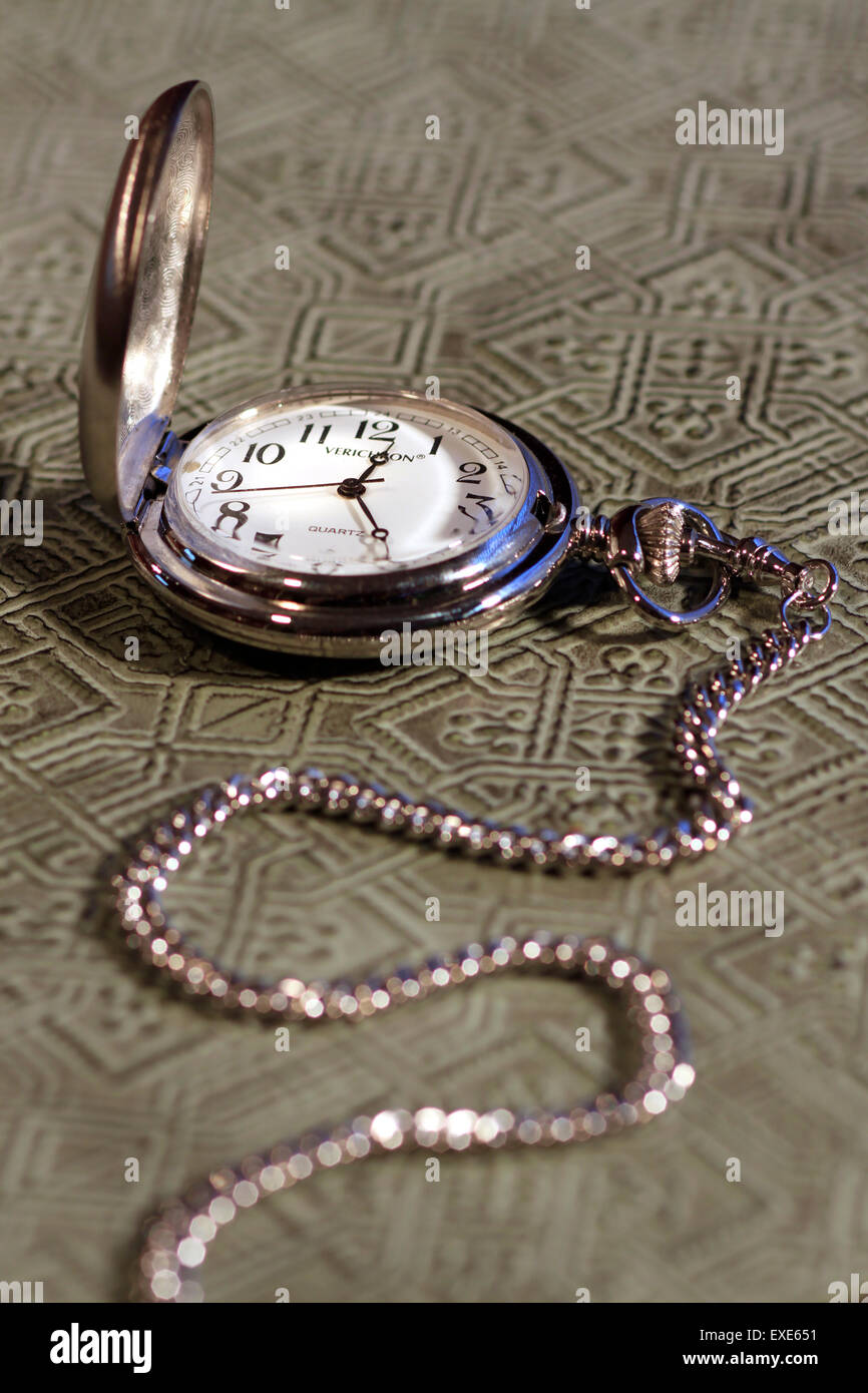 Pocket watch on textured surface Stock Photo