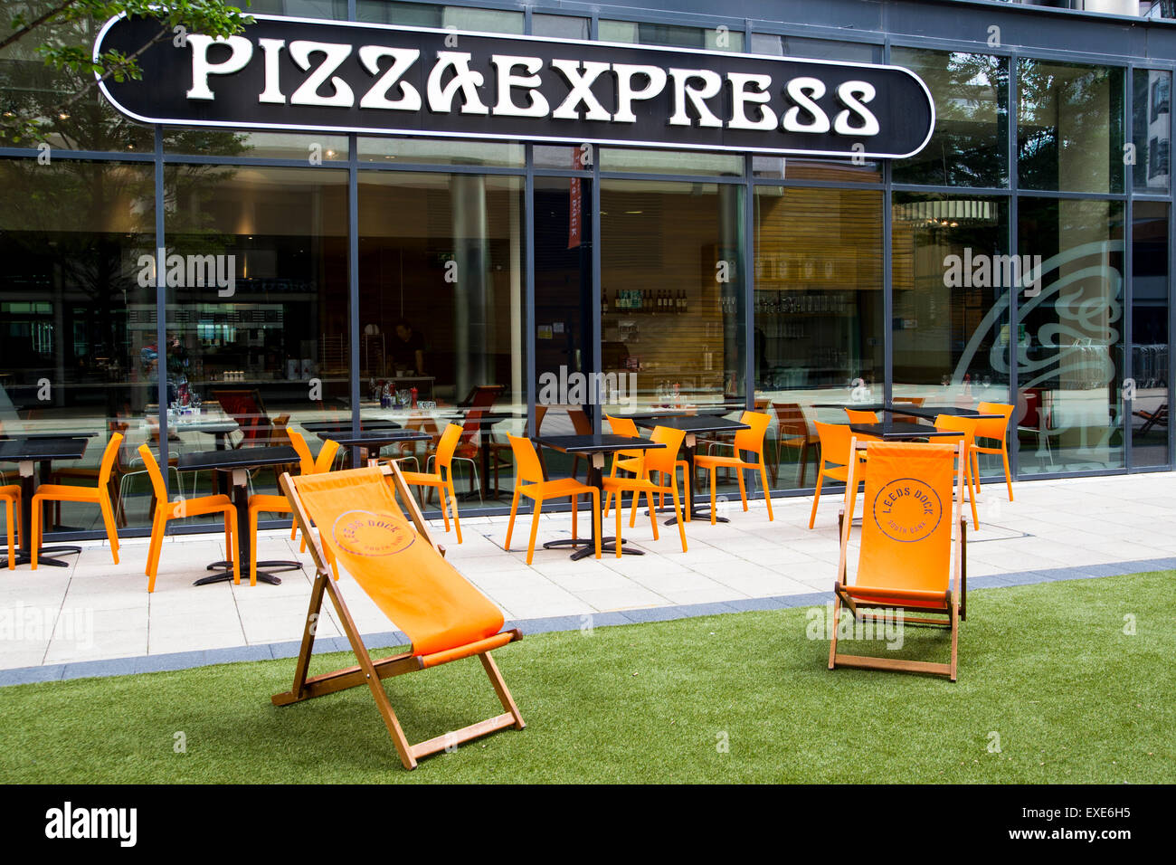 Deckchairs outside Pizza Express at Leeds Dock Stock Photo Alamy