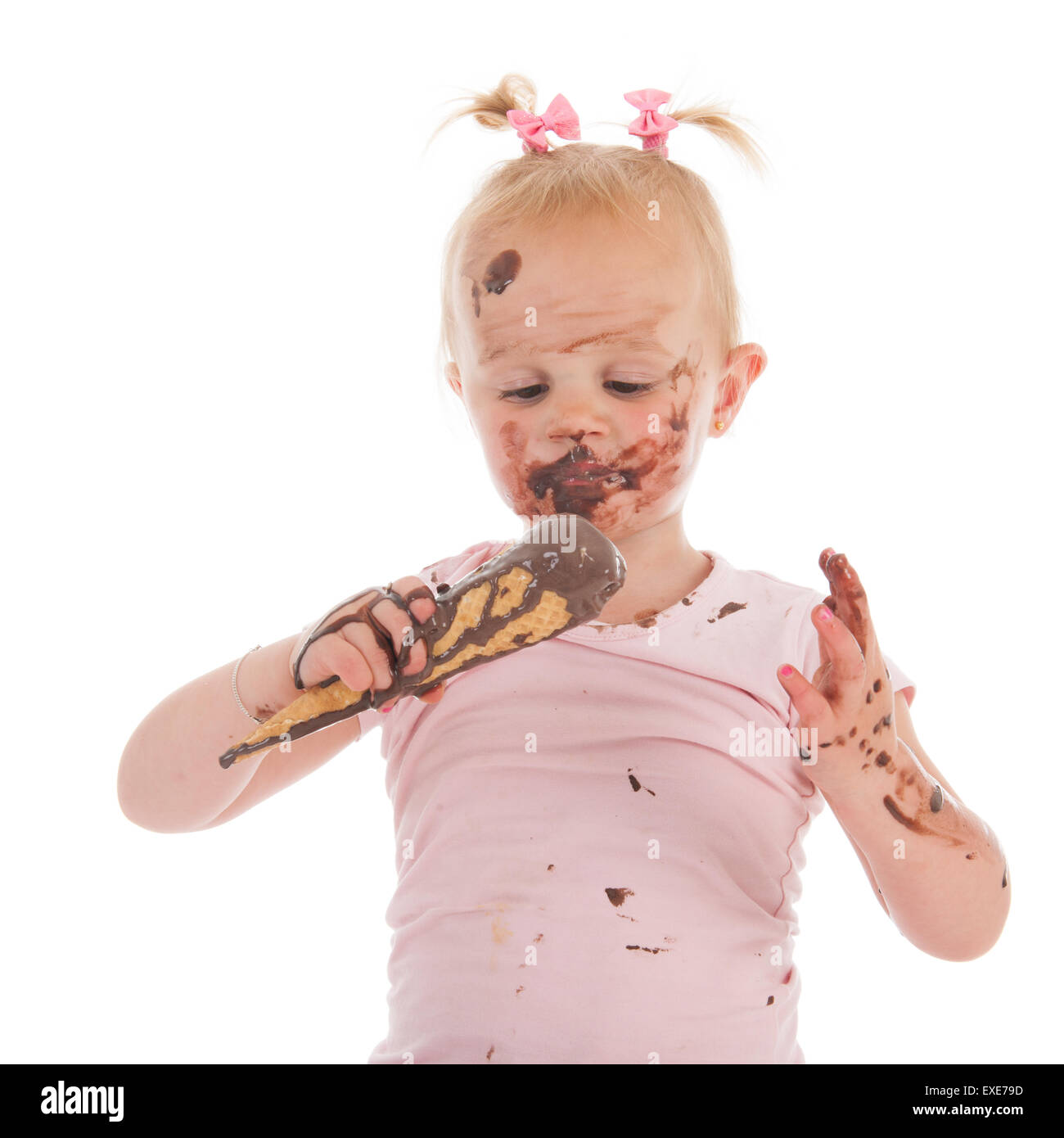 Portrait toddler girl eating chocolate ice cream isolated over white