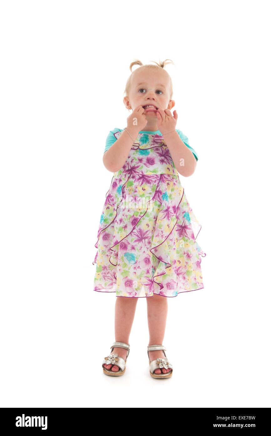 Funny face toddler girl standing in studio in summer dress isolated over white background Stock Photo - Alamy Funny face toddler girl standing in studio in summer dress isolated over white background Stock Photo - Alamy