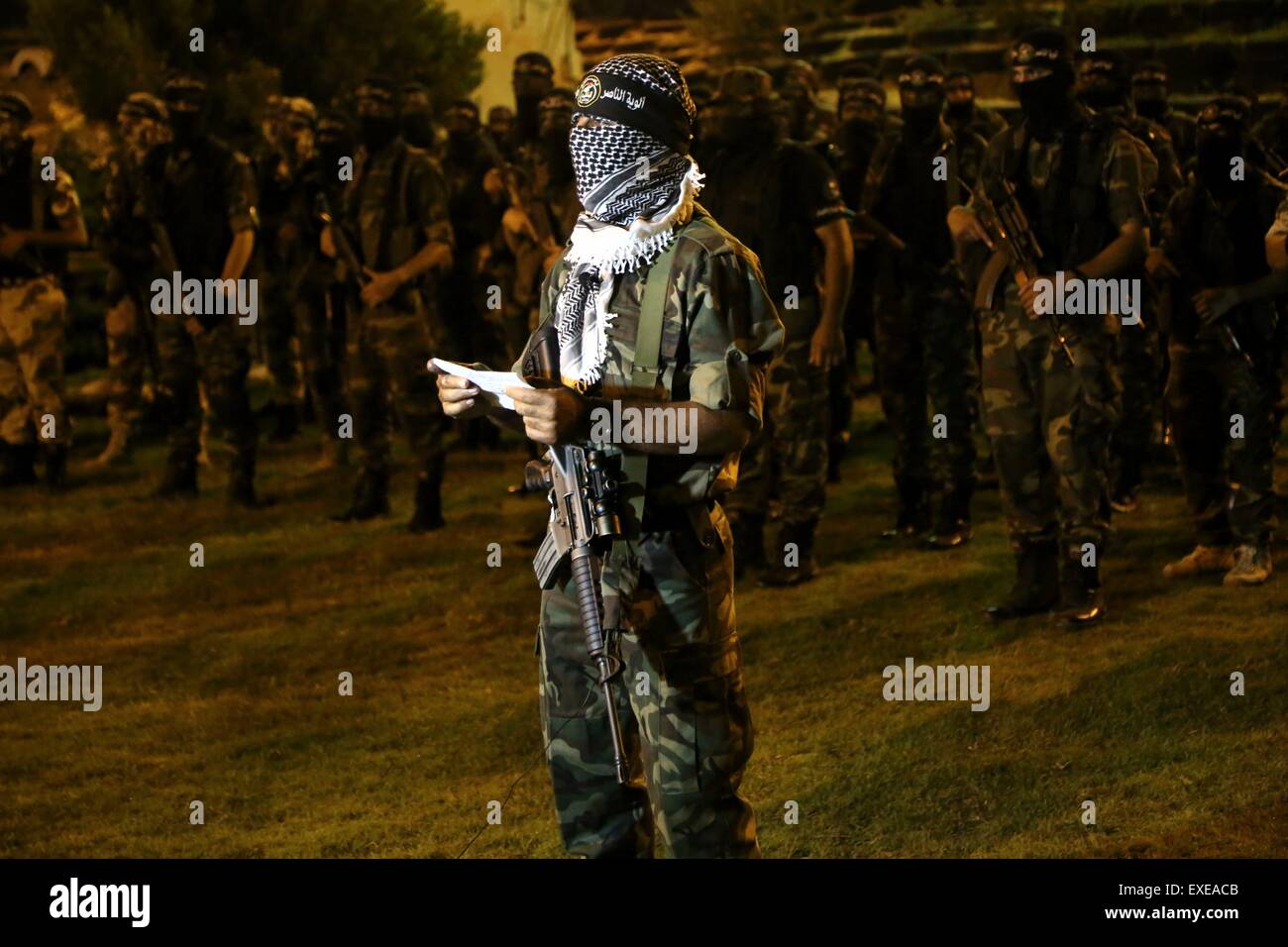 Gaza, Palestine. 12th July, 2015. Militants from al-Nasser Salah al-Deen Brigade, the military wing of the Popular Resistance Committees march during an anti-Israel rally marking the first anniversary of the 50-day Israeli war on Gaza Strip last summer. © Nidal Alwaheidi/Pacific Press/Alamy Live News Stock Photo