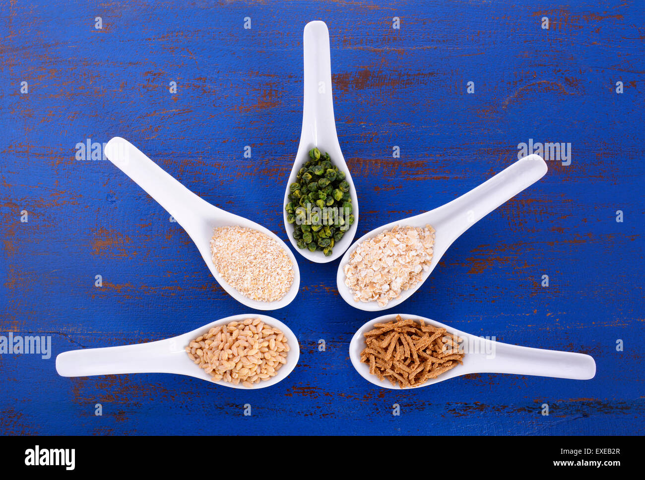 Healthy High Fiber Prebiotic Grains in serving spoons, including wheat