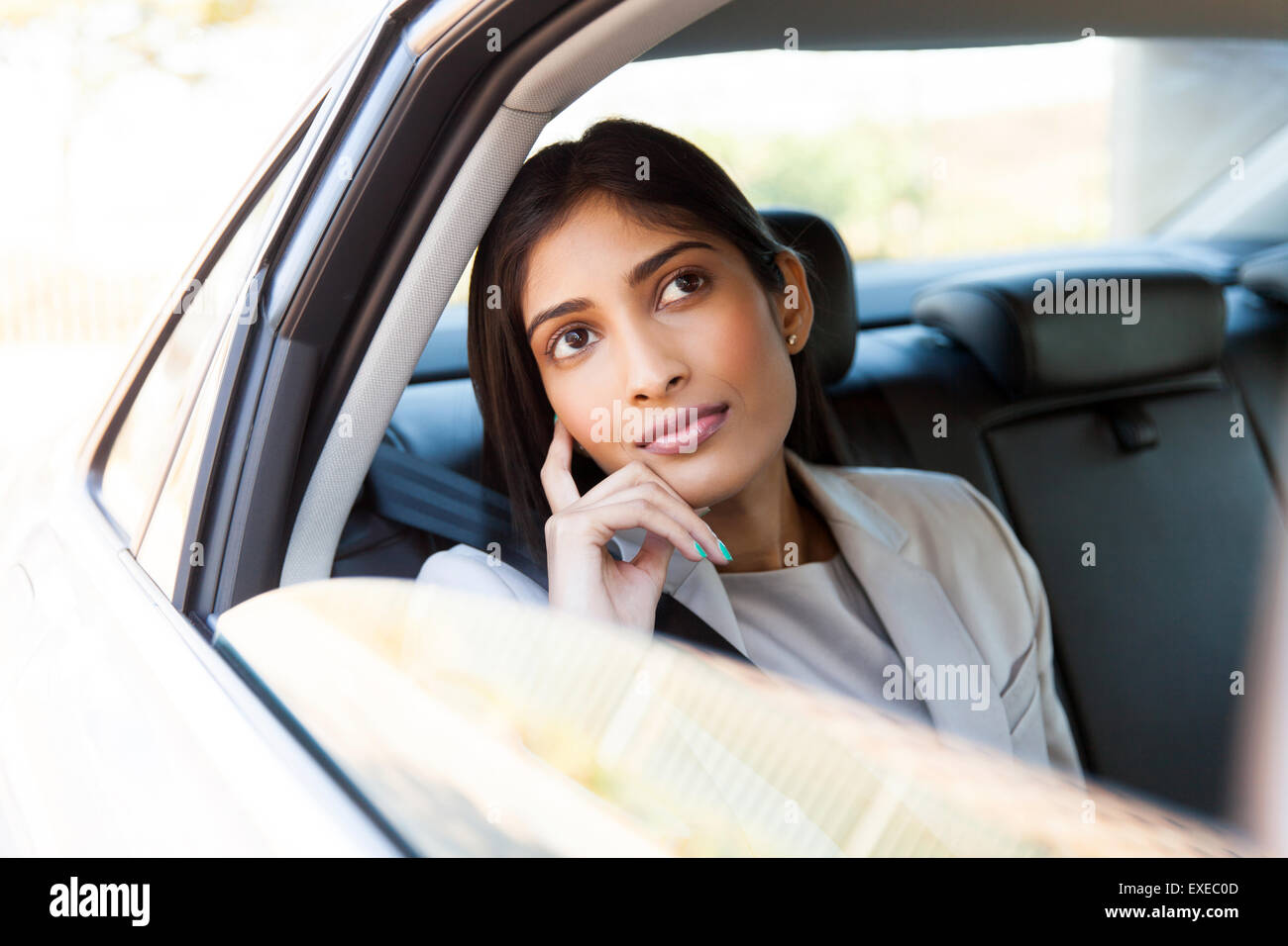 beautiful young Indian businesswoman in a taxi Stock Photo