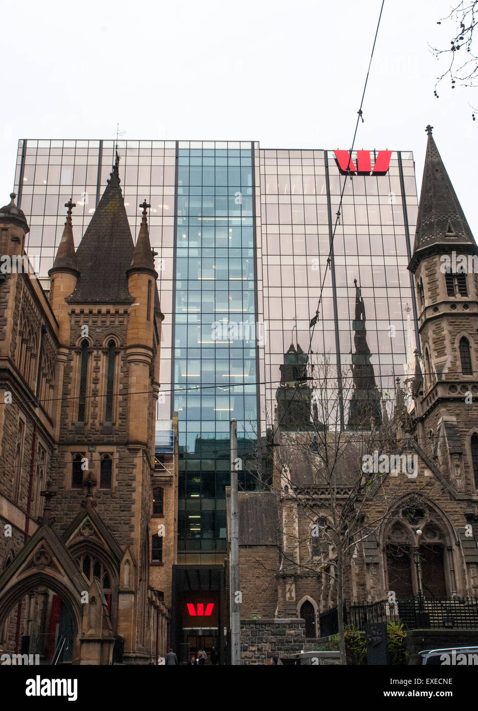 God and Mammon: Victorian-era church buildings in Collins Street overshadowed by a banking corporation, Melbourne Stock Photo