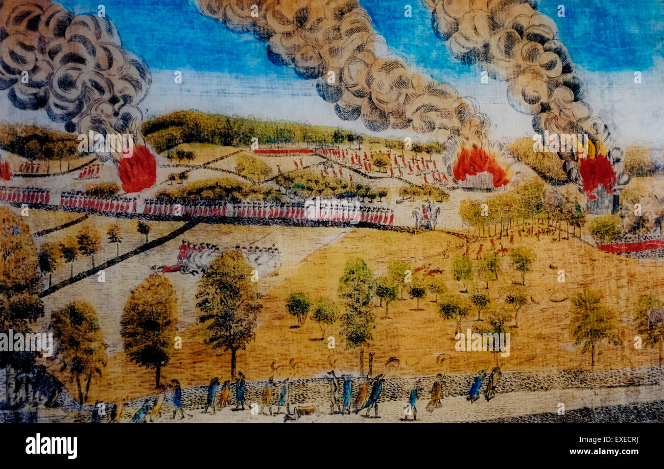 View of the South Part of Lexington - British redcoats marching for the safety of Boston while Colonist militia shoot at them from behind walls.  The burning homes were set fire by the British in order to prevent the Americans from using them for cover, USA Revolutionary War - 1775 Stock Photo