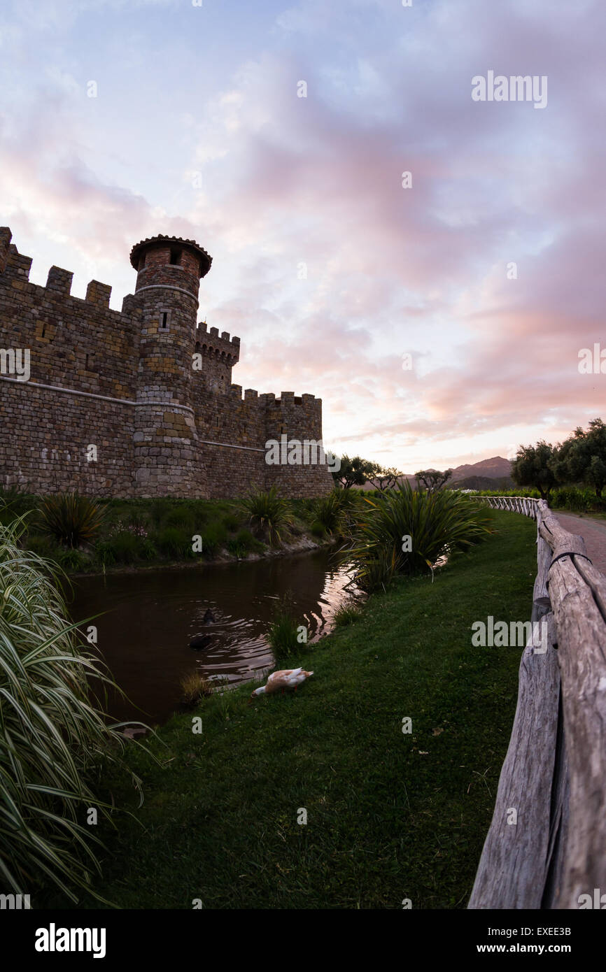 Castle in Napa Valley at sunset with a reflection on the mote Stock Photo