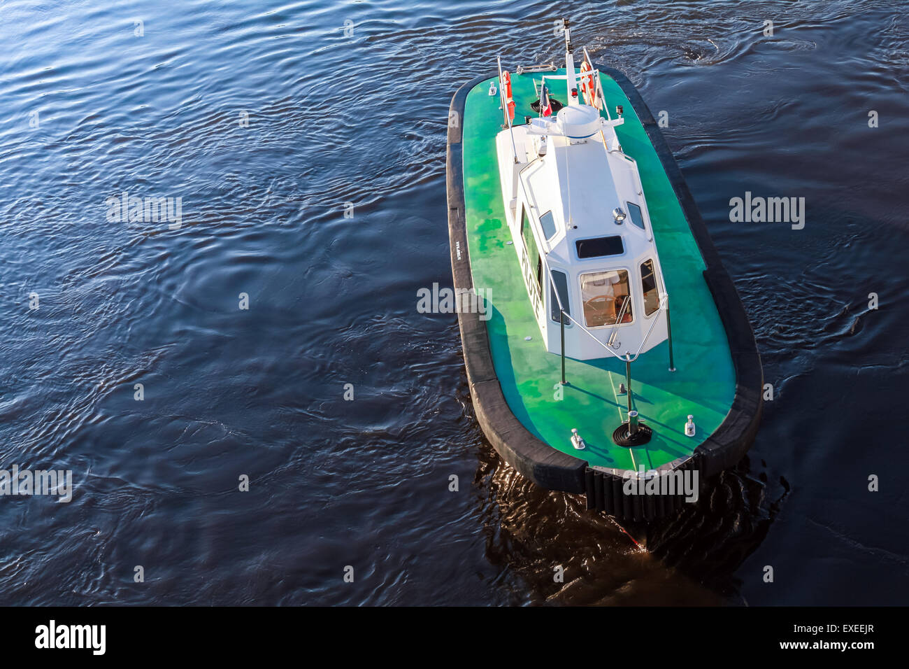 Pilot Boat With Green Deck And Black Hull On A Sea Water Stock Photo pilot-boat-with-green-deck-and-black-hull-on-a-sea-water-stock-photo