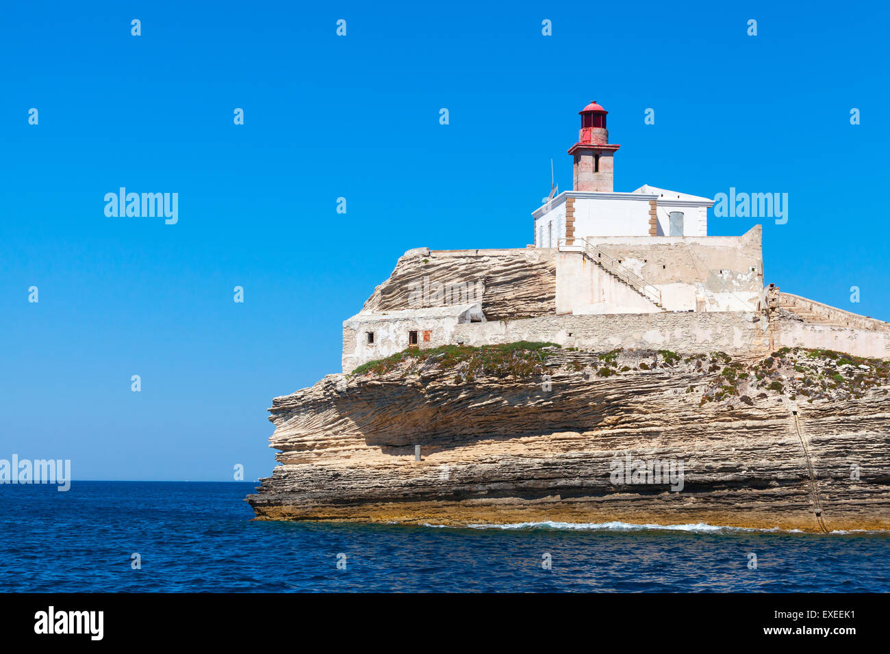 Madonetta lighthouse, red tower and white building. Entrance to Bonifacio port, Corsica island, France Stock Photo