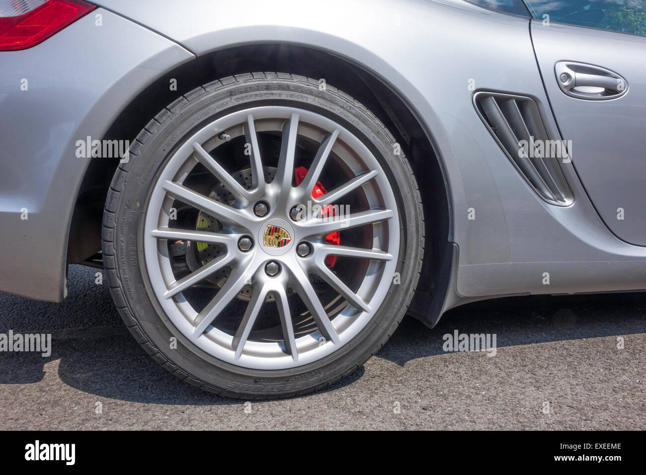 Rear wheel detail of a silver Porsche Cayman S sports car Stock Photo