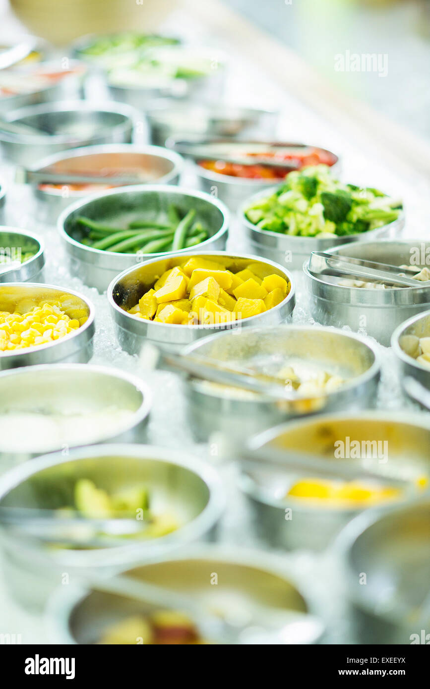 Bowls Of Mixed Fresh Organic Vegetables In Salad Bar Display Wood