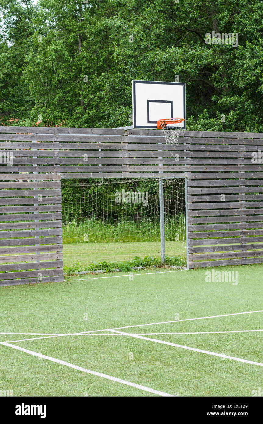 Soccer goal and basketball hoop on outdoor playground with synthetic