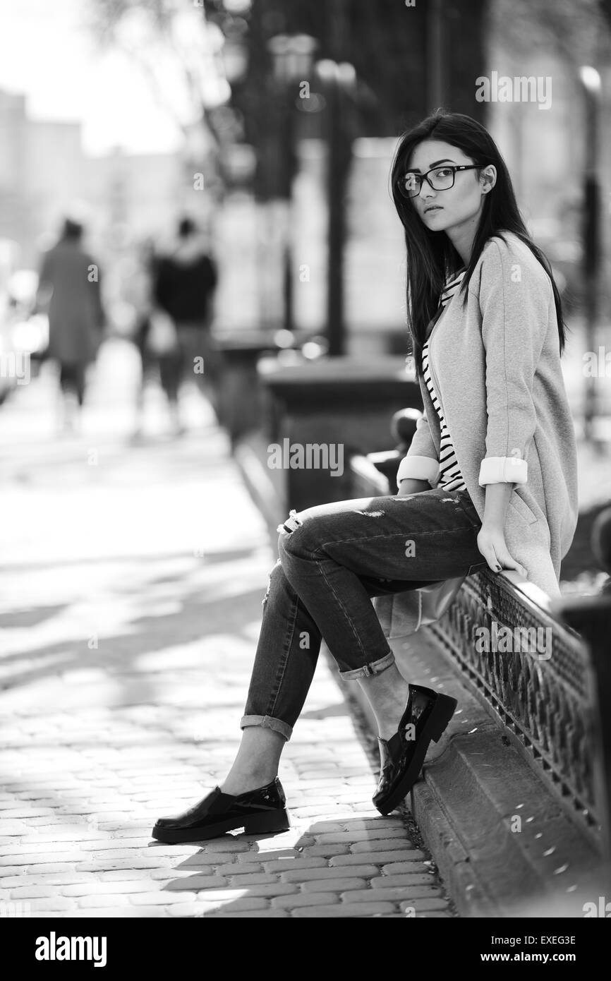 Beautiful model in a coat and glasses Stock Photo - Alamy