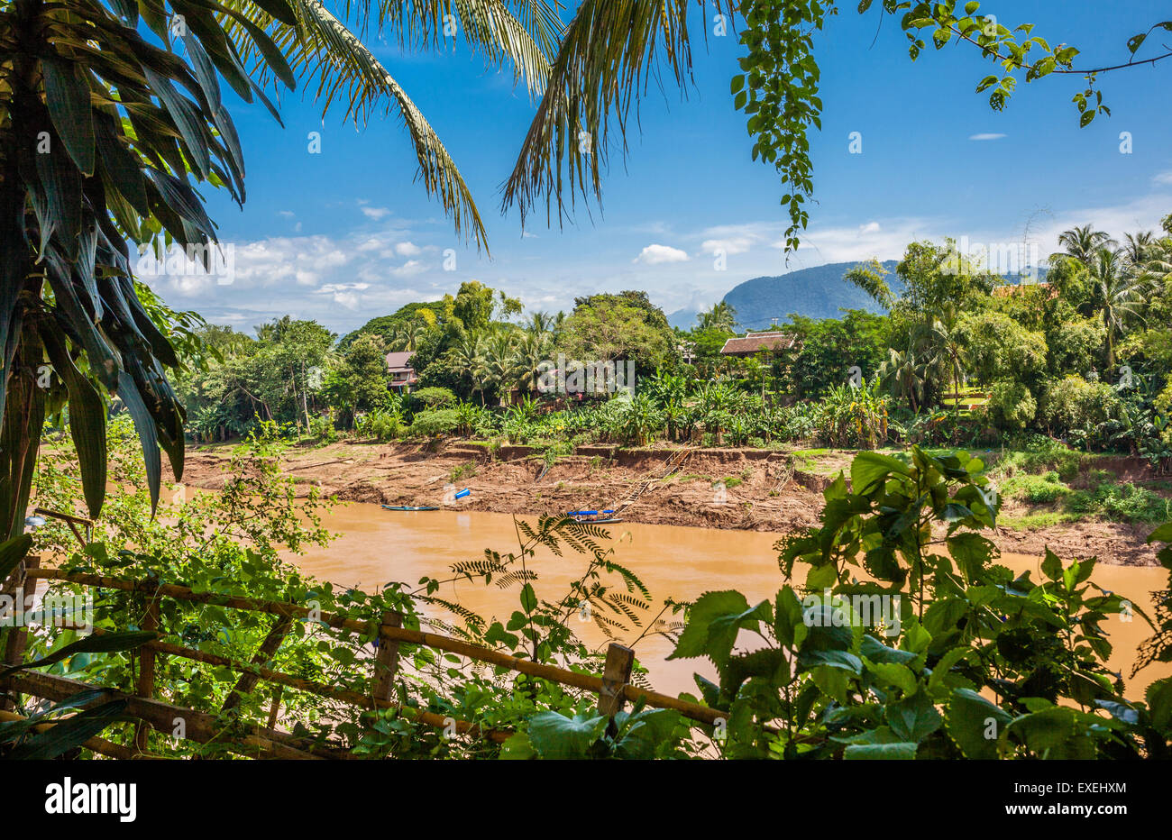 Lao People's Democratic Republic, Laos, Luang Prabang, view of Nam Khan River flowing through lush tropical vegetation Stock Photo