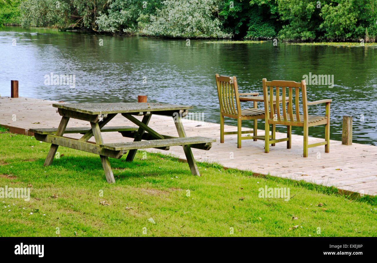 Outdoor furniture by the River Yare at Bramerton, near Norwich, Norfolk, England, United Kingdom. Stock Photo