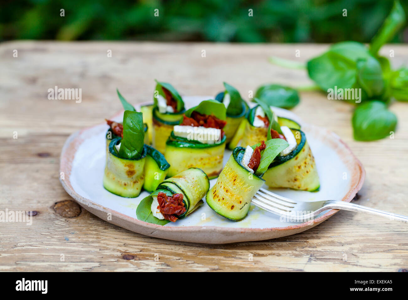 Zucchini rolls with goat cheese, sun dried tomatoes and basil Stock