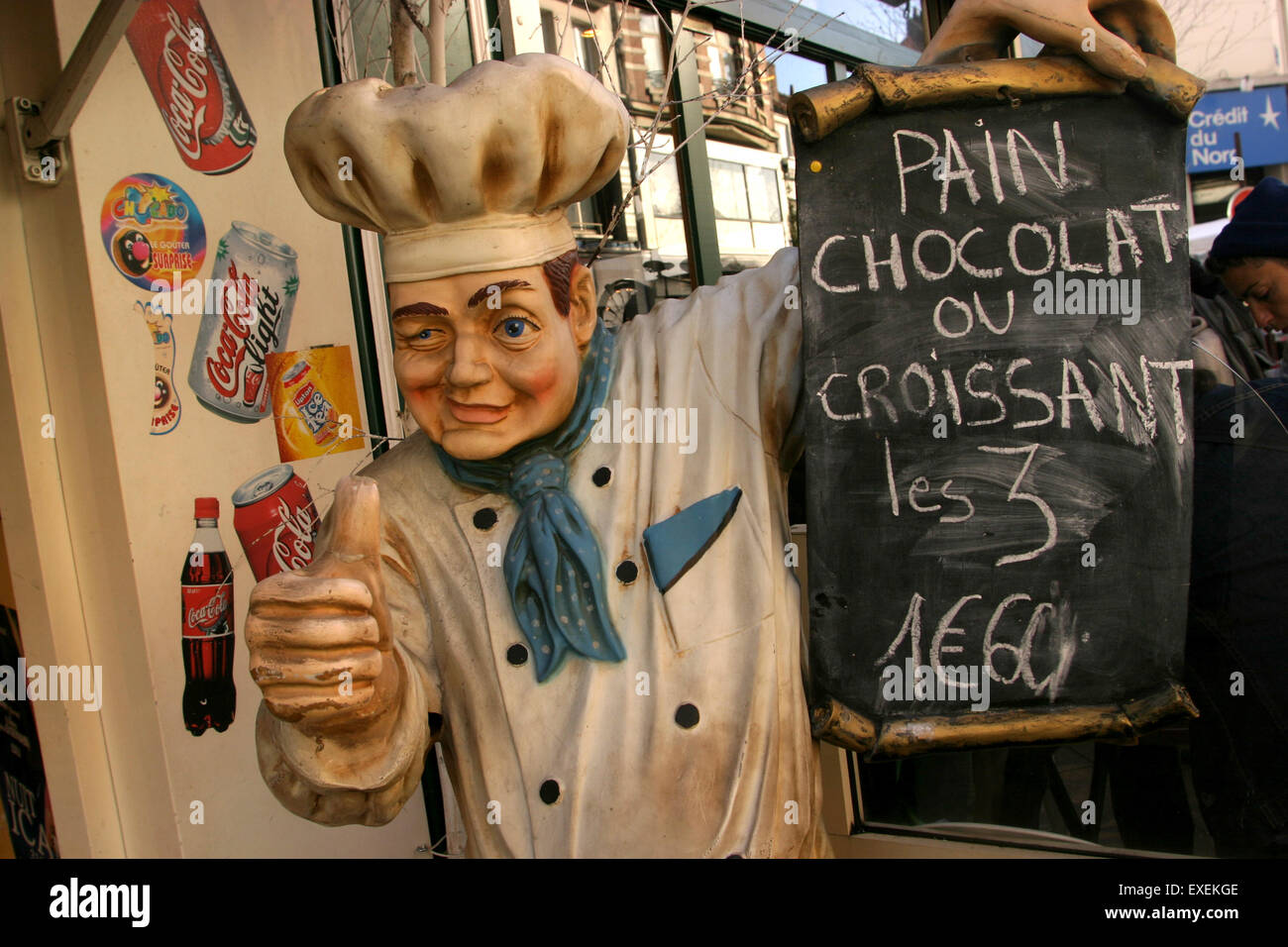 A chef mannequin advertising pain au chocolat and croissant pastries in a street market in Lille, France Stock Photo
