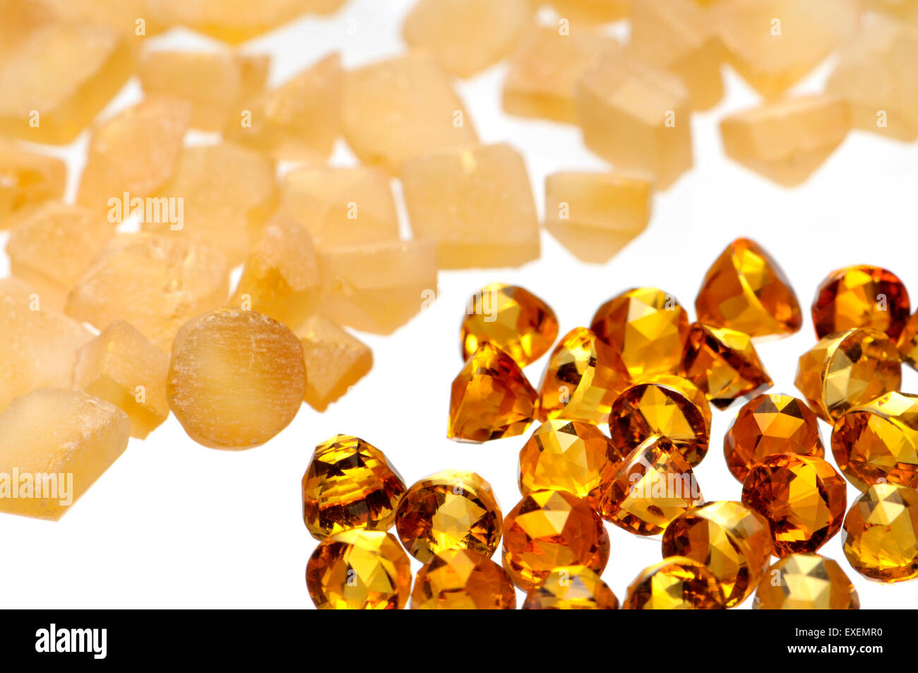 Roughly formed and finely cut citrine gemstones Stock Photo