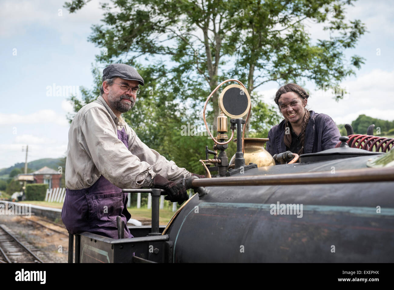 Liz and Dave driving a steam engine at Bala Lake Railway, Wales Stock