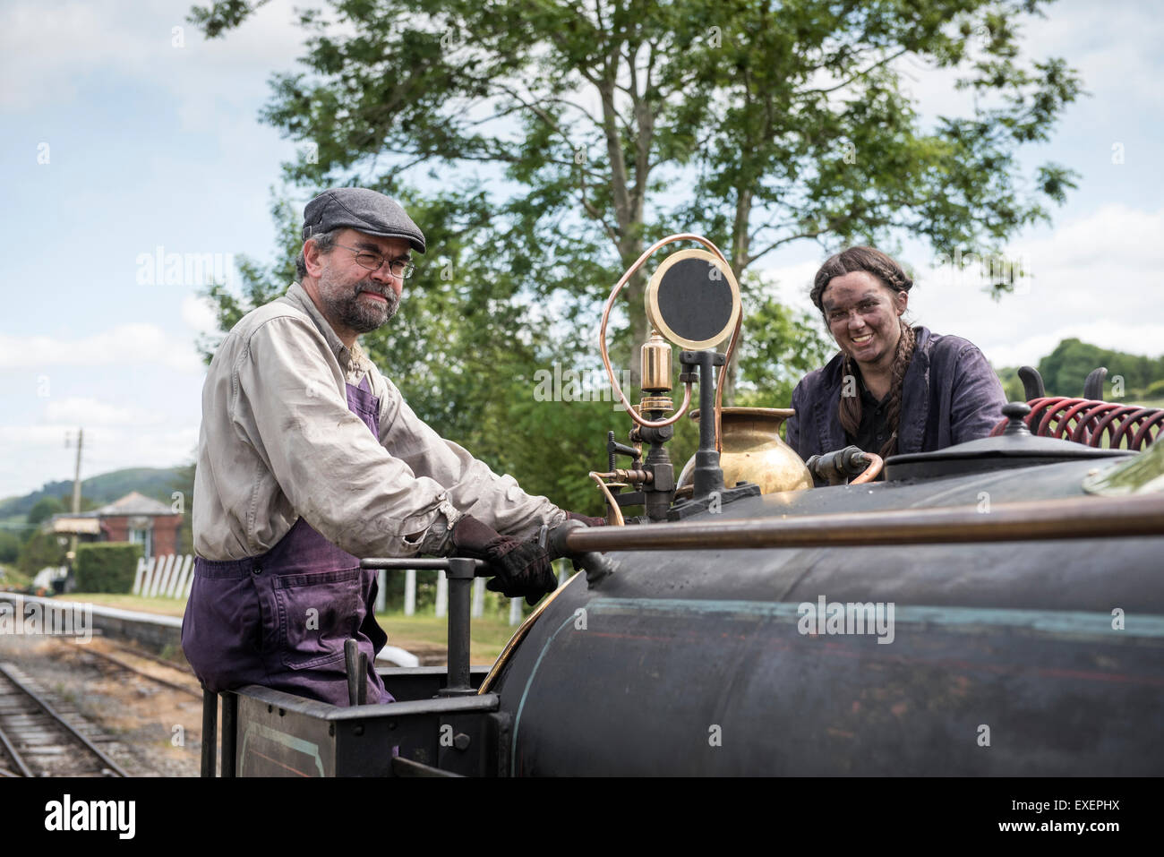 Liz and Dave driving a steam engine at Bala Lake Railway, Wales Stock Photo