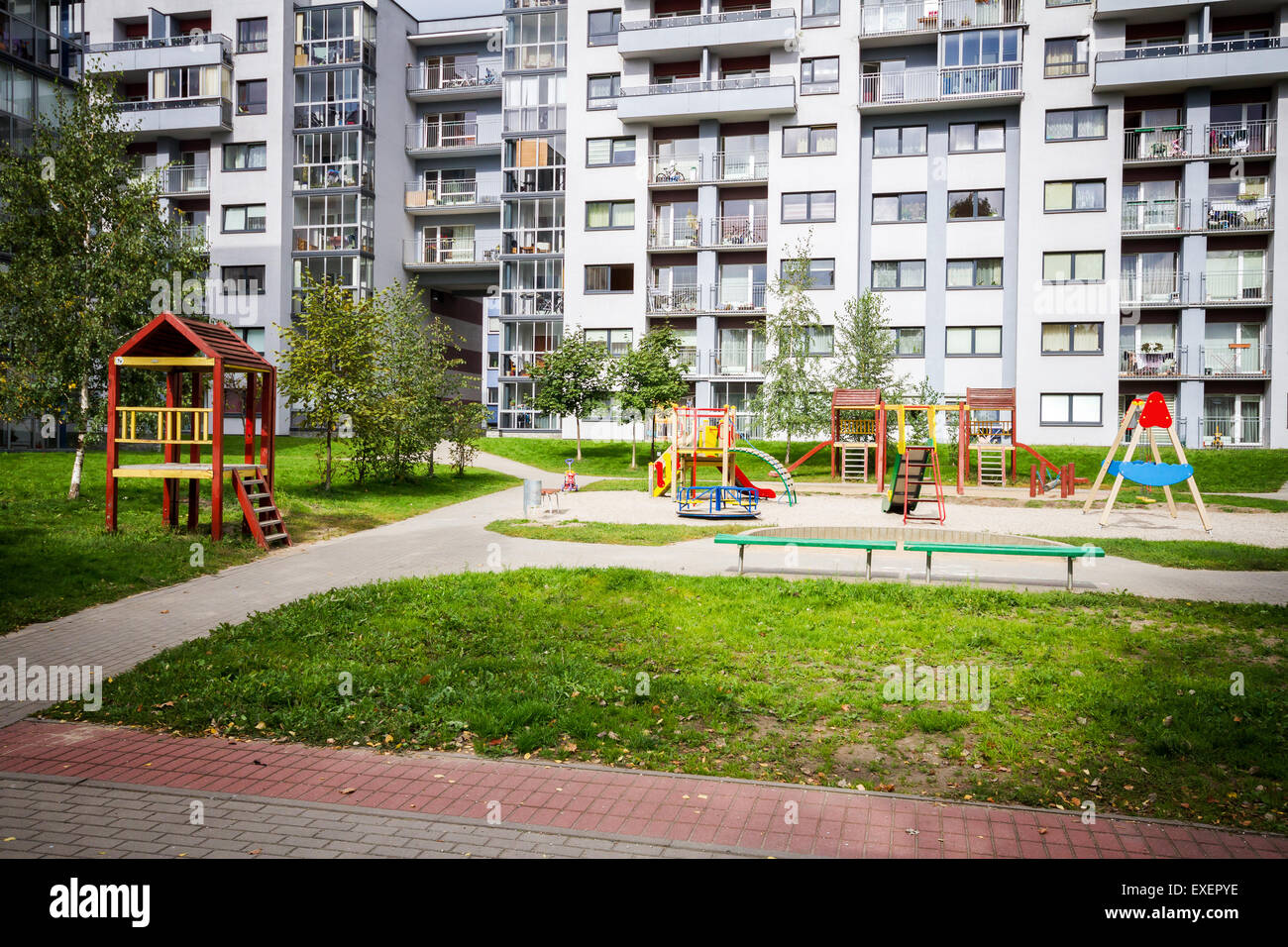 Modern apartment building with kids playground Stock Photo - Alamy