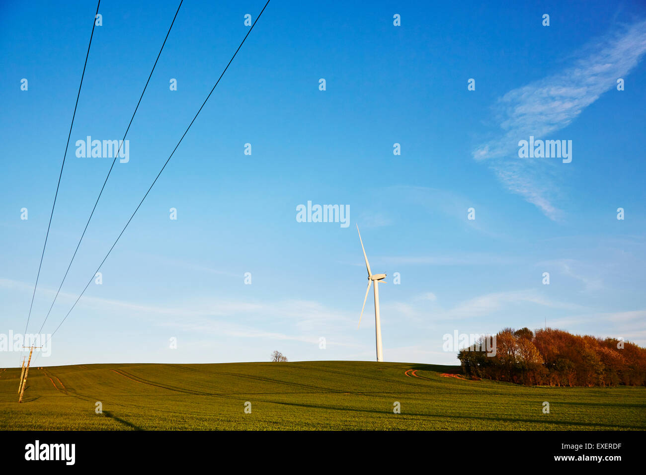 View of a wind turbine on top of a hill. Stock Photo