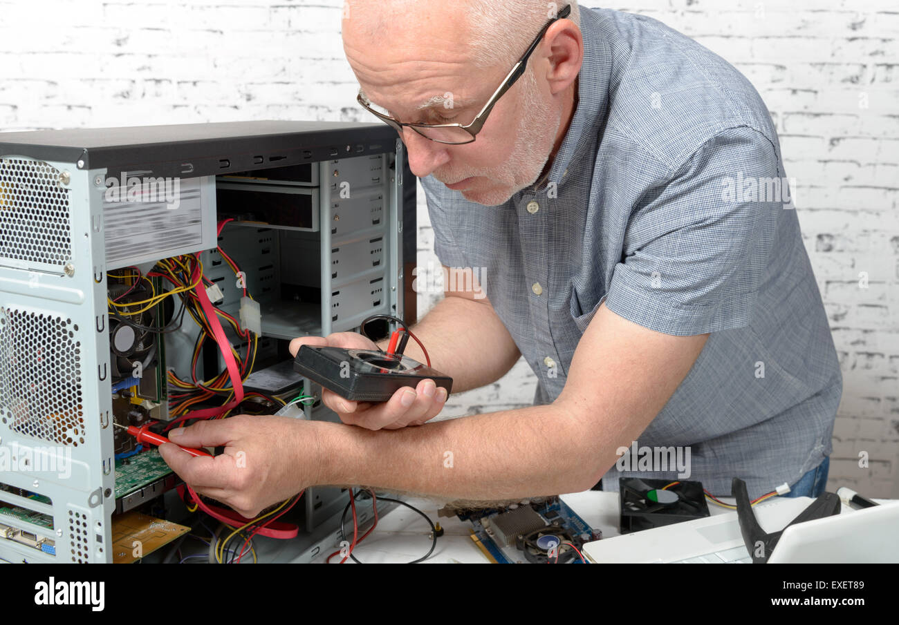 a technician repairing a computer with different tools Stock Photo Alamy
