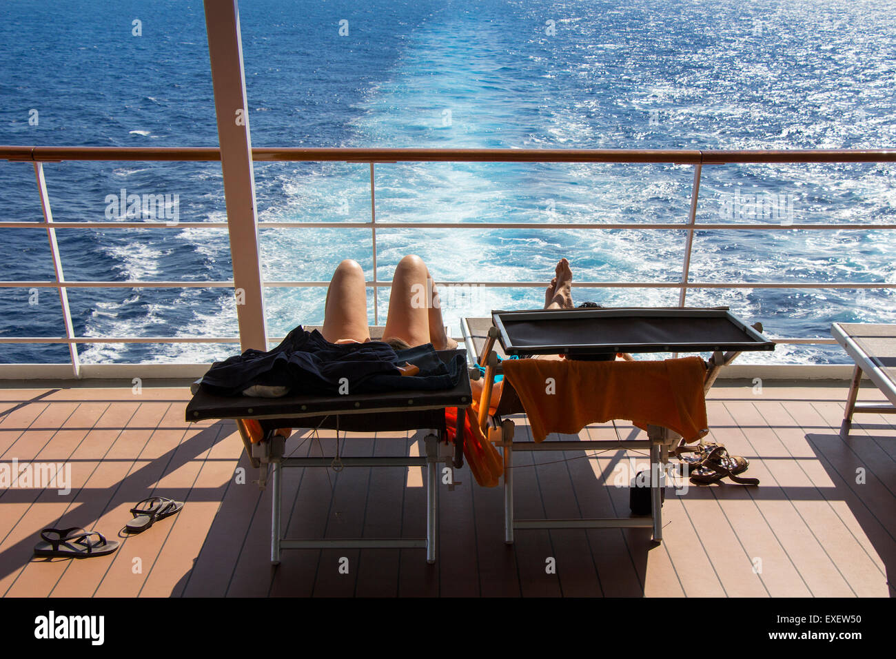 Young couple sunbathing on the deck cruise ship Stock Photo