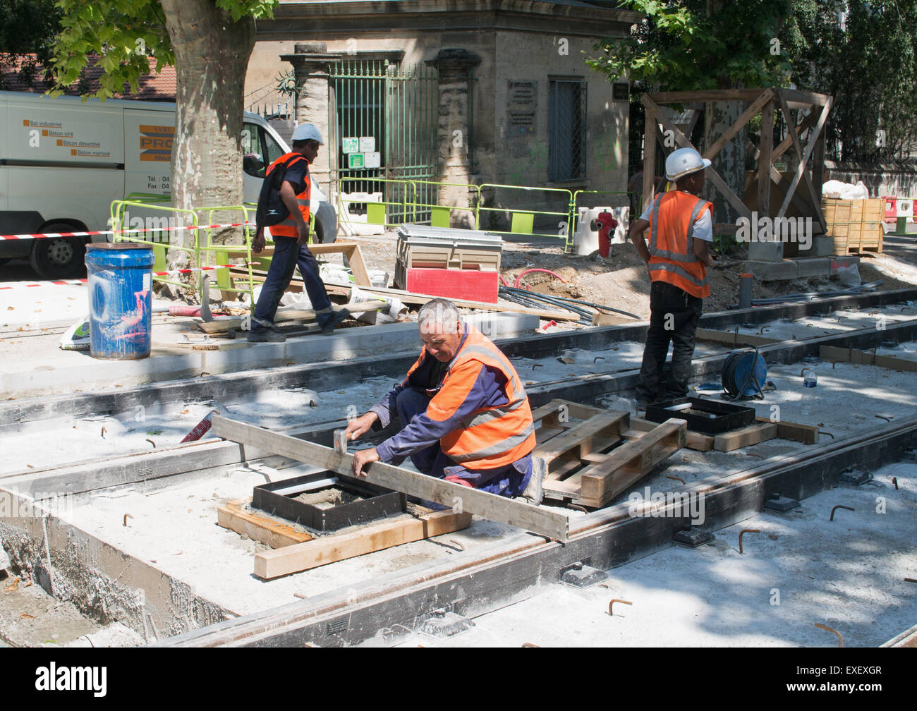 Men working on new tram tracks within Montpellier,  Hérault , Languedoc-Roussillon, France, Europe Stock Photo