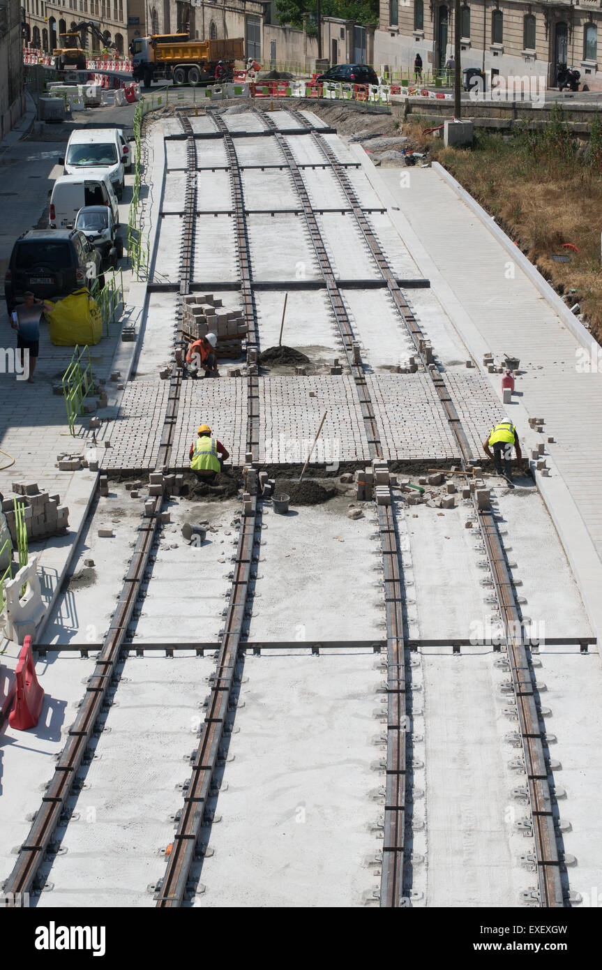 Men working on new tram tracks within Montpellier,  Hérault , Languedoc-Roussillon, France, Europe Stock Photo