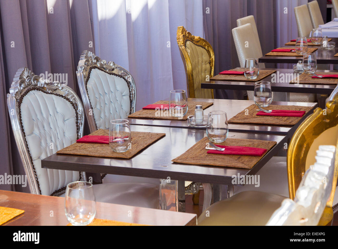 restaurant tables antique French style palace prepared with cutlery and glasses Stock Photo