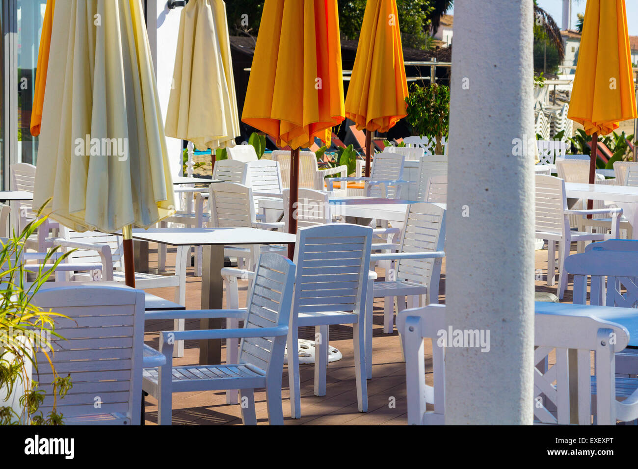 white chairs and tables with umbrellas orange Stock Photo Alamy
