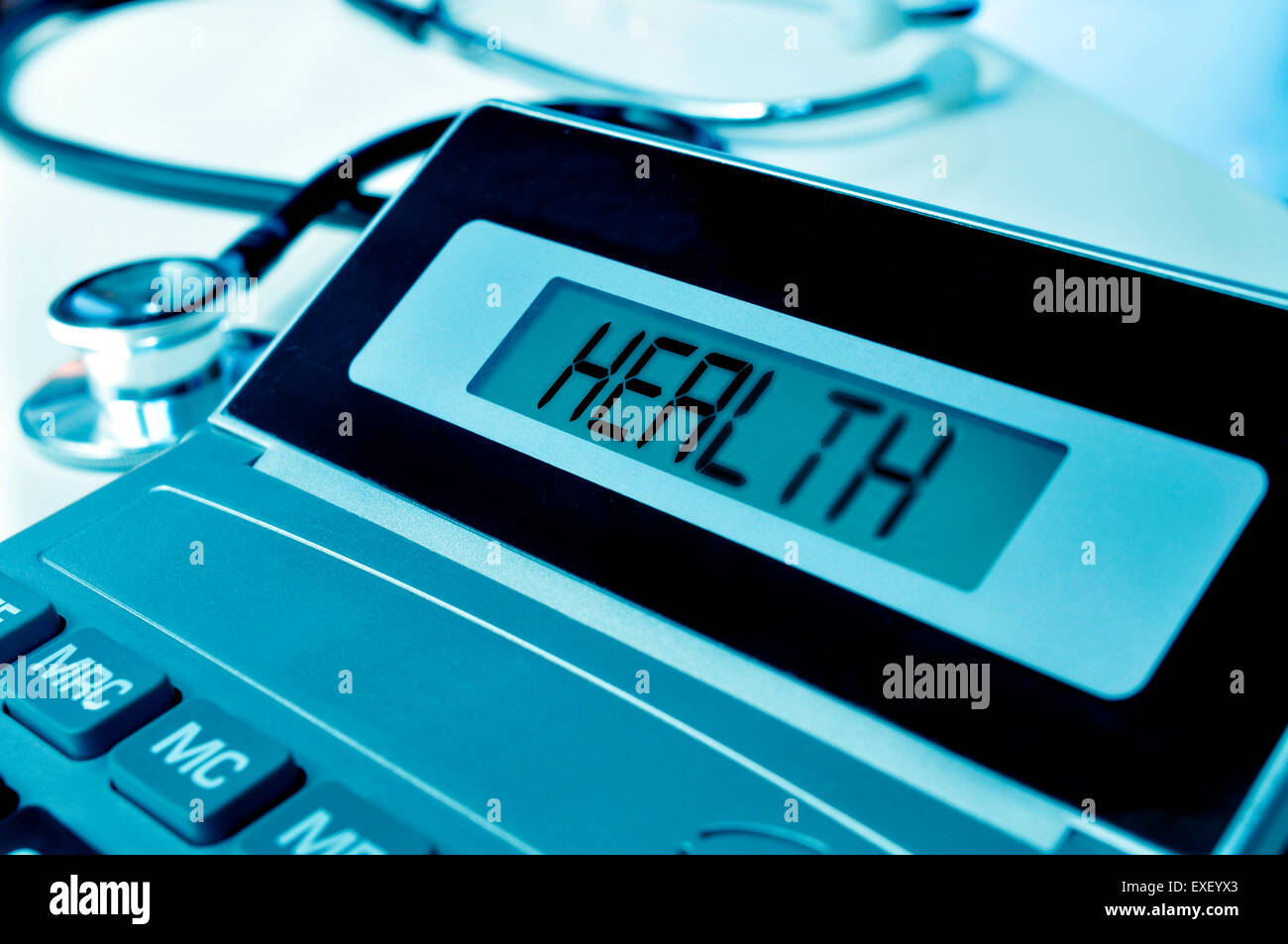 closeup of an electronic calculator with the word health in its display and a stethoscope, depicting the concept of the healthca Stock Photo