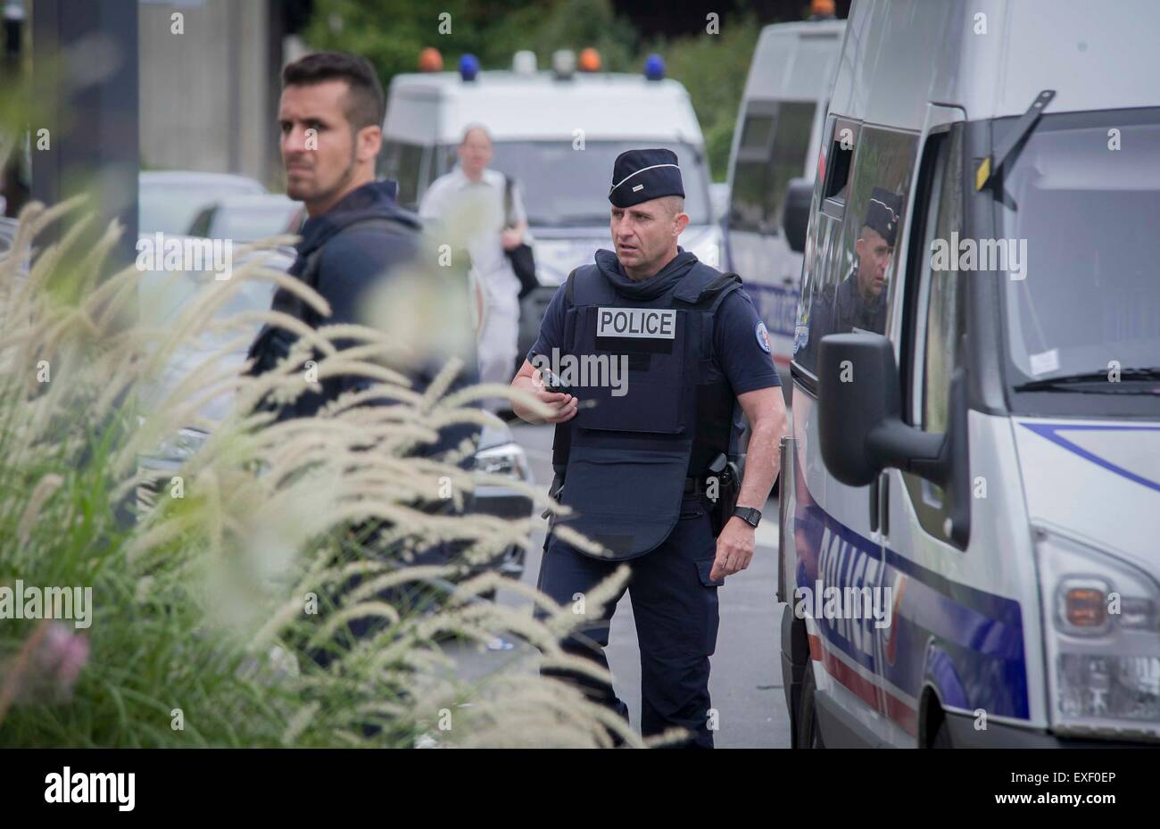 Paris, France. 13th July, 2015. Police officers stand guard outside the site of a hostage helding in Paris, France, July 13, 2015. About 18 people have been evacuated from the shopping center where gunmen held employees hostage Monday morning in Villeneuve-la-Garenne, west Paris, police said. Credit:  Chen Xiaowei/Xinhua/Alamy Live News Stock Photo