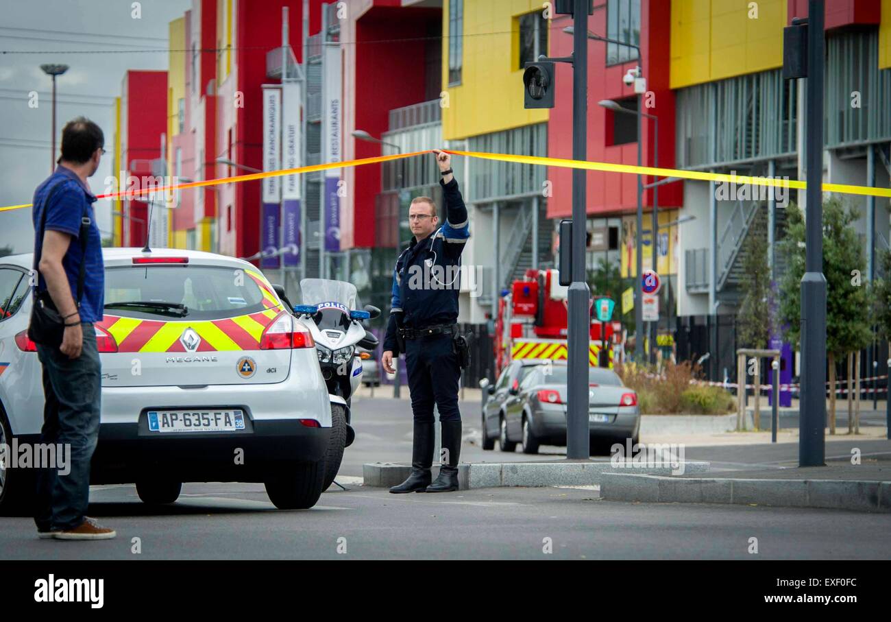 Paris, France. 13th July, 2015. A police officer stands guard outside the site of a hostage helding in Paris, France, July 13, 2015. About 18 people have been evacuated from the shopping center where gunmen held employees hostage Monday morning in Villeneuve-la-Garenne, west Paris, police said. Credit:  Chen Xiaowei/Xinhua/Alamy Live News Stock Photo