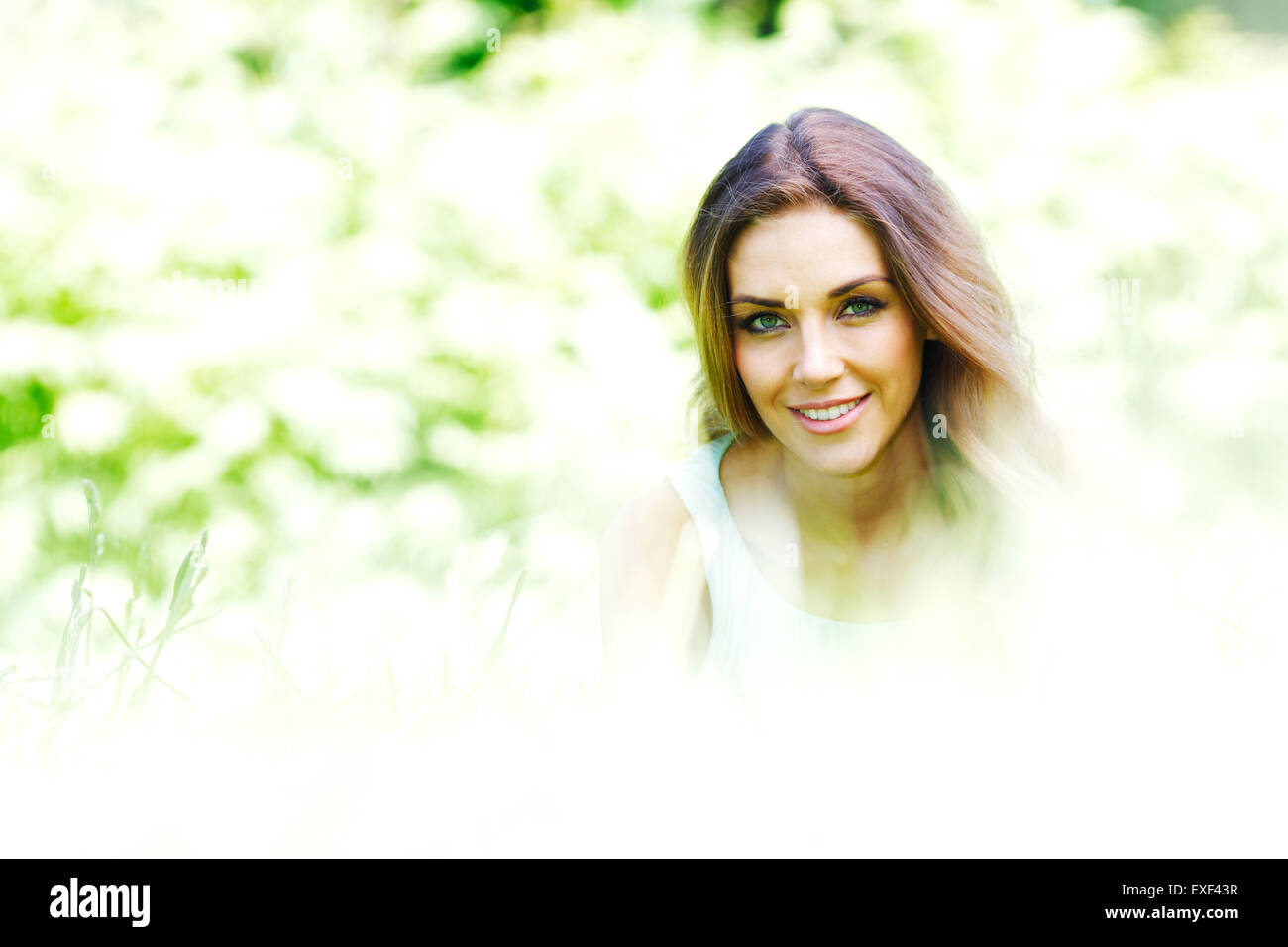 young woman in blue dress lying on grass Stock Photo - Alamy