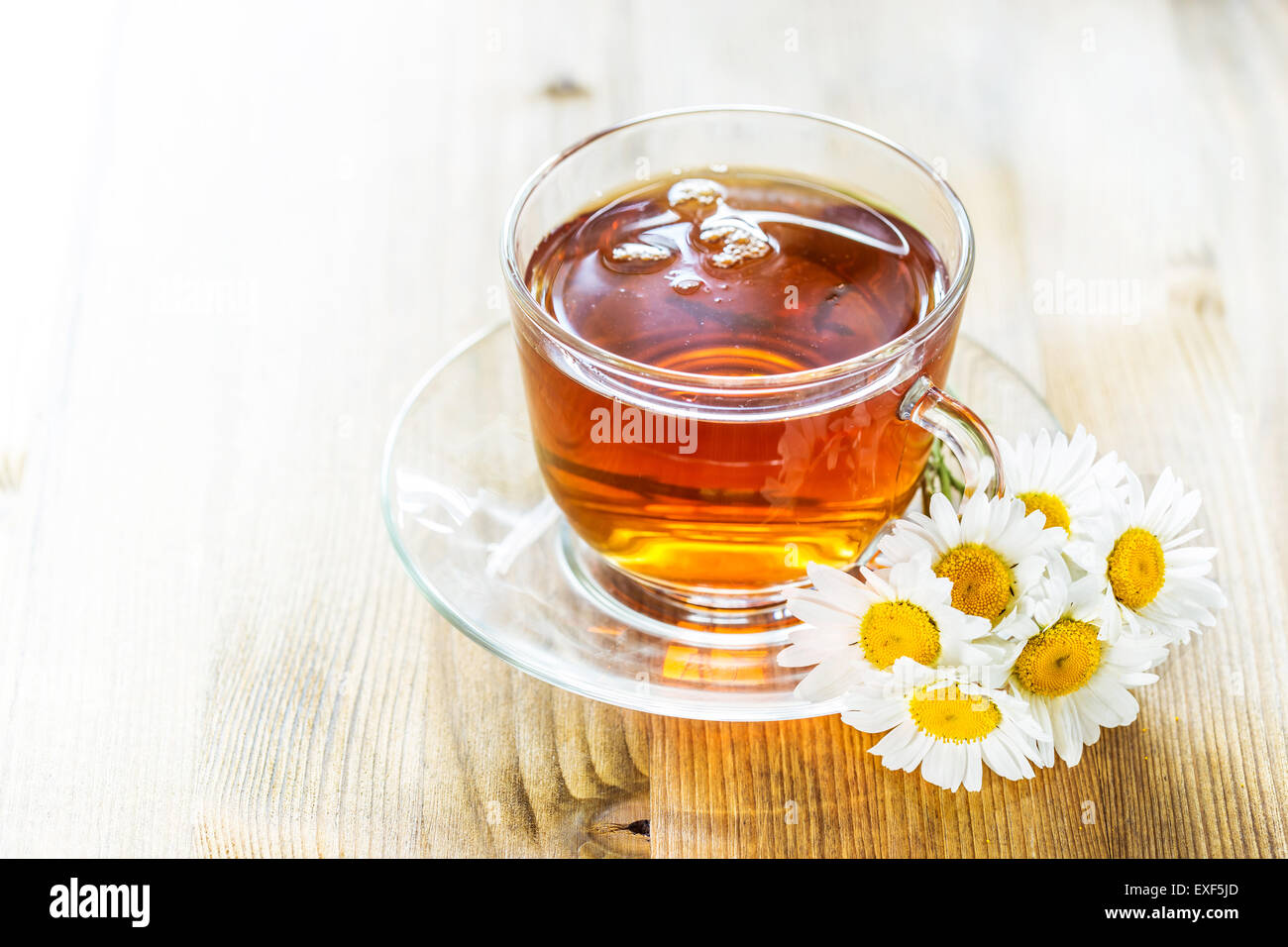 Cup of tea with chamomile flowers on rustic wooden background Stock ...