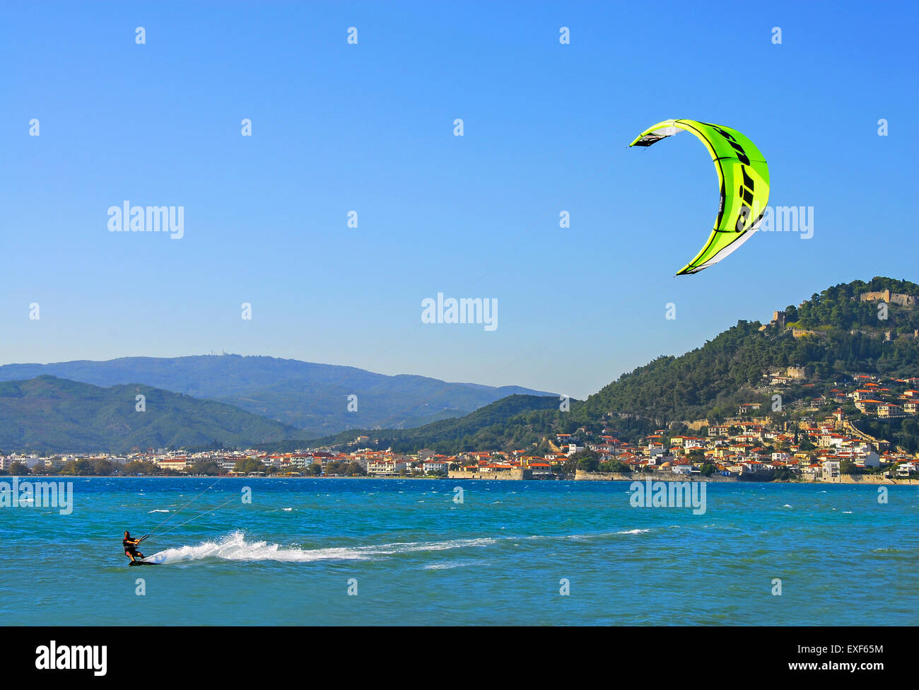 Water sports at Gribovo beach, at the seafront of Nafpaktos town and its castle in Aetoloacarnania region,  Greece Stock Photo