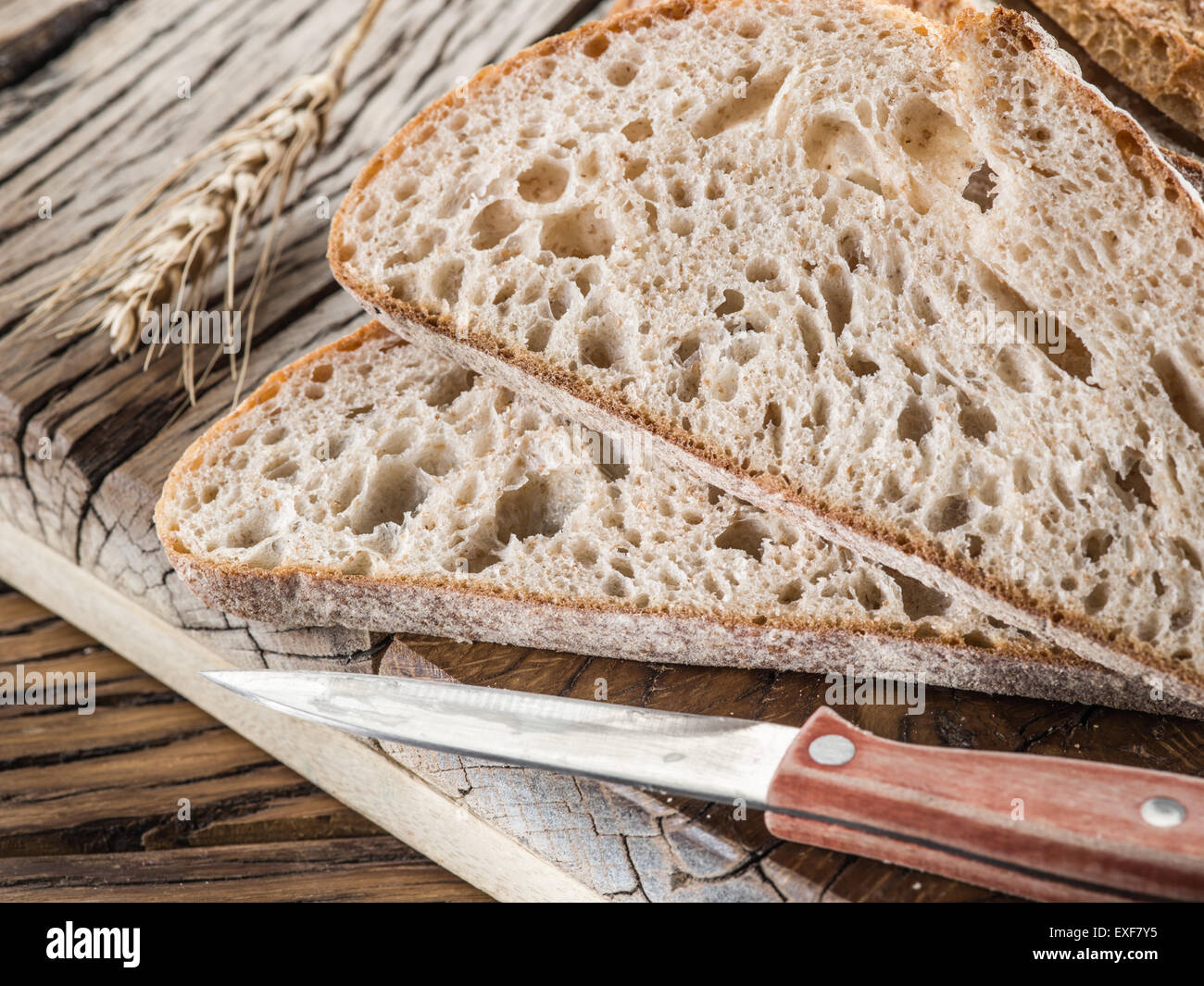 Sliced black bread on the old wooden plank. Stock Photo