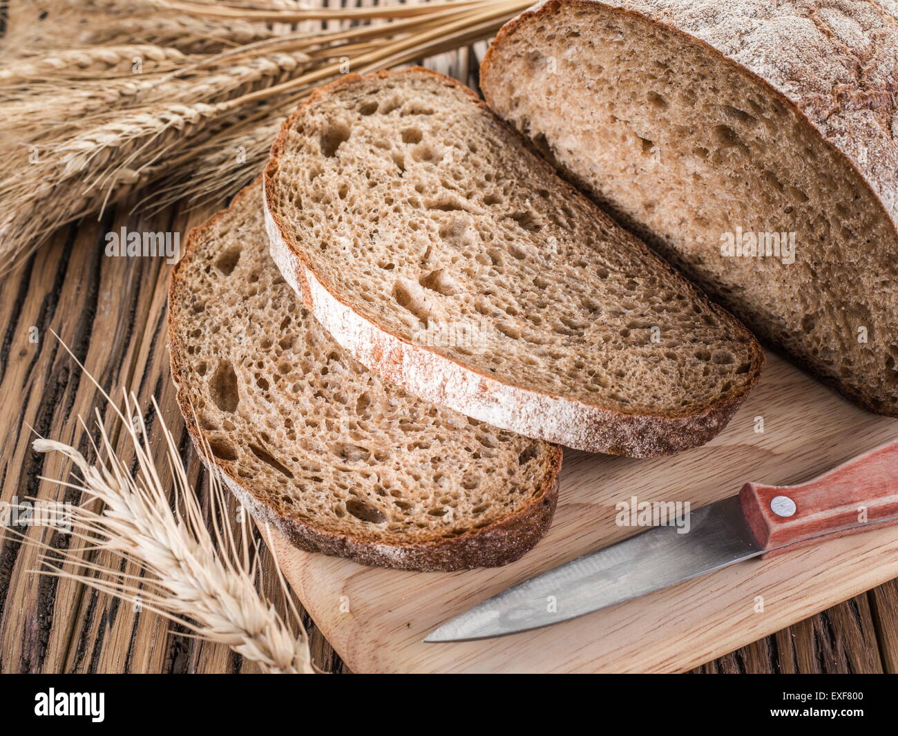 Sliced black bread on the old wooden plank. Stock Photo