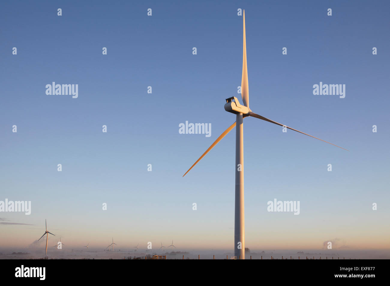 Wind turbine against blue sky Stock Photo - Alamy