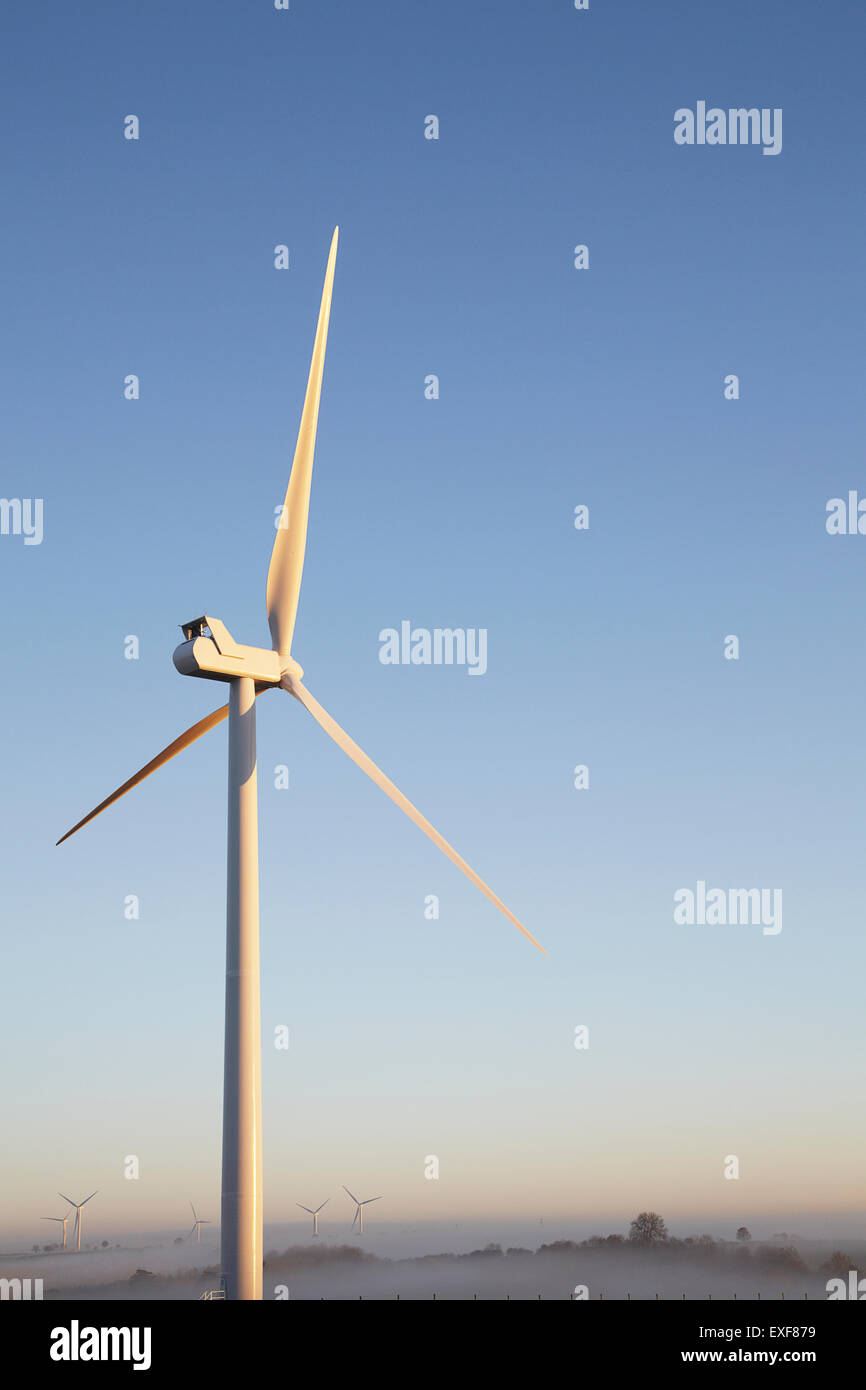 Wind turbine against blue sky Stock Photo